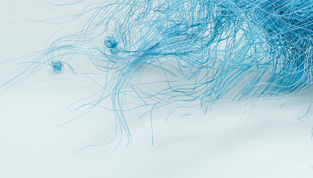 Blue fine threads tangled on a soft light background