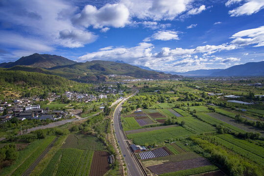 Aerial View of Lijiang Countryside and Mountains Under Blue Sky