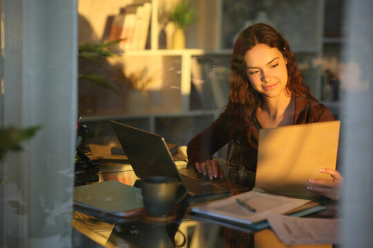 Telecommuter checking documents working at home