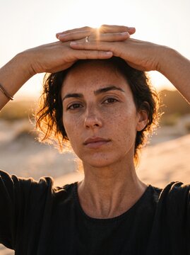 Hands shading face from harsh sunlight conceptual sun protection skin care