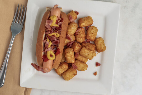 hot dog served with tater tots