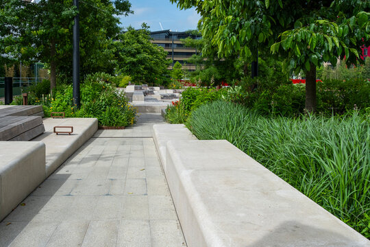 Public landscaped walkway in London England with modern planters greenery and seating showing a green urban space with contemporary city design
