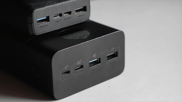 Black portable power banks. Focus on charging ports. Concept of modern gadgets and technology. Backup power, electricity, energy storage, blackout.