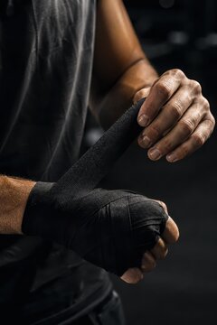 Boxer winding a cotton wrap around a closed fist
