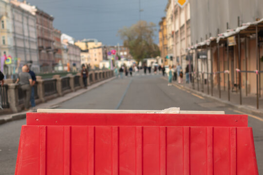 The street is blocked off by a red barrier.
