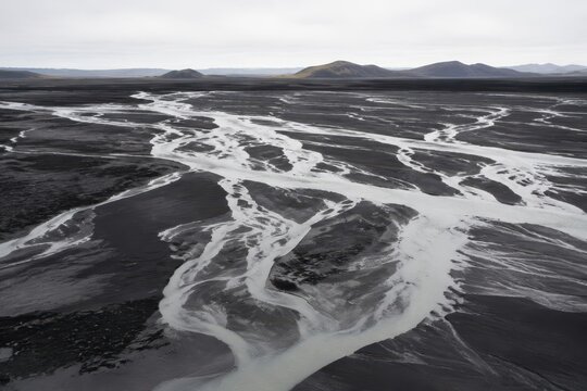 Braided meltwater channels cutting across a dark ash plain