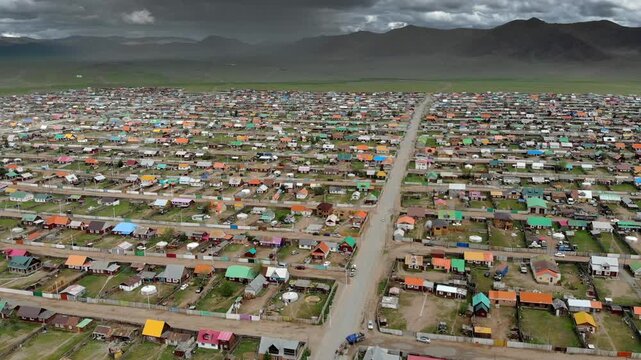 Urban housing districts in Mongolia form a colorful city grid of roofs streets and blocks.