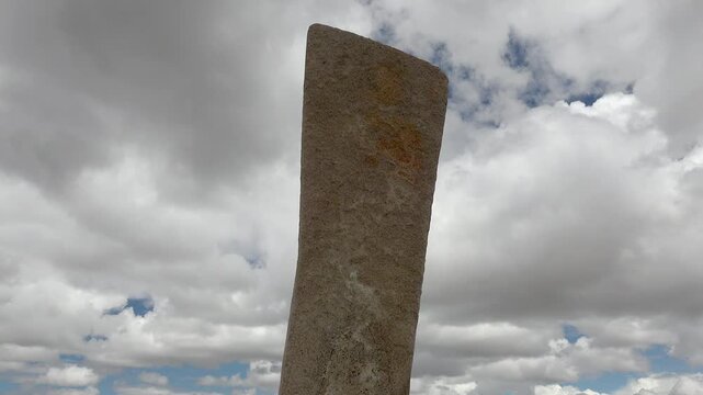 Asian deer stone monument bears ritual symbols on an ancient burial stele in open steppe.