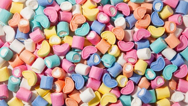 Abundance of colorful pastel marshmallow shapes scattered as background with marshmallows colorful confectionery