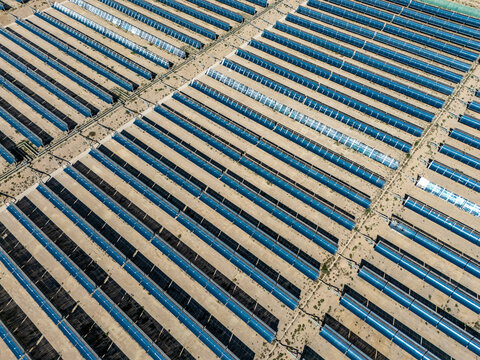 aerial view of neat parabolic trough solar thermal power plant arrays
