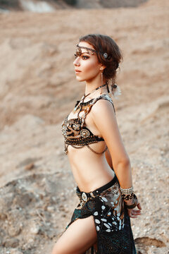 Fashion Beauty and stylish girls. Spirituality dance. Beautiful Sexy Woman With Luxury glossy gold eastern Makeup danceing tribal fusion. Indian accessories (oriental jewelry)