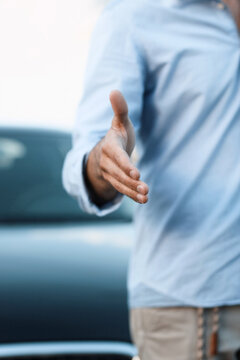 A business man with an open hand ready to seal a deal