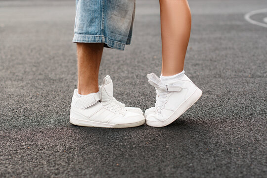 Young hip-hop couple kissing in asphalt. Kiss love standing.
