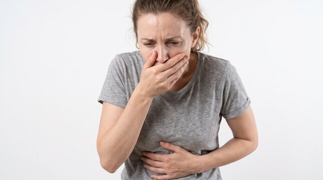 Young woman feeling nauseous with stomach ache and hand over her mouth against white background