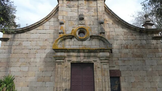 Front view of the historic stone Church of Santa Mar&iacute;a de Mones in Pet&iacute;n, Ourense, Galicia, Spain, featuring traditional religious architecture and a simple rural fa&ccedil;ade