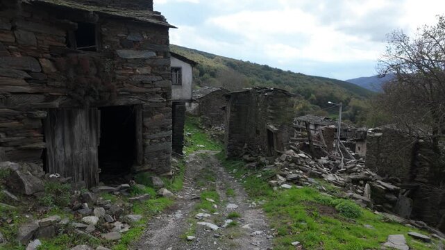 Old abandoned stone house in Santoalla do Monte, Galicia, Spain, surrounded by vegetation and showing the decay of a remote rural settlement affected by depopulation