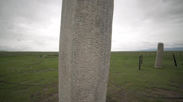 Tonyukuk inscription monument in Mongolia shows ancient runic writing carved on stone.
