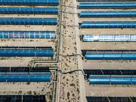 aerial view of parabolic trough solar thermal power plant in desert