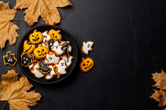 Halloween cookies on black stone background with copy space