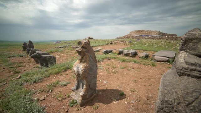 Shiveet Ulaan excavation site in Mongolia showing animal style stone sculptures and ruins.
