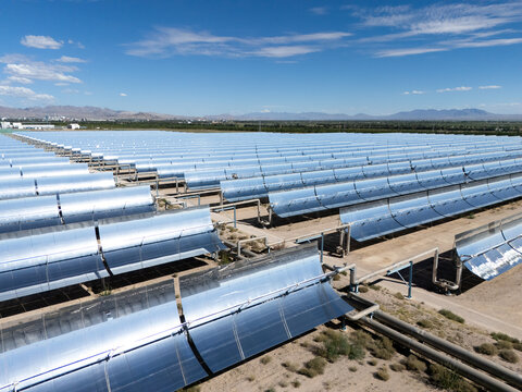 rows of parabolic trough solar thermal power plant in desert