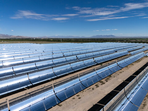 panoramic view of parabolic trough solar power plant under blue sky