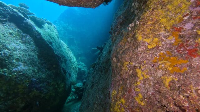 Diving through a rock formation in thailand.