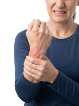 Middle-aged woman suffering from wrist pain, holding her hand with visible redness and a pained expression, isolated on white background