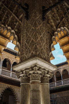 Ornate multi lobed arches and marble columns in the Patio de las Doncellas