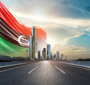 Libya national flag waving behind the cityscape. Libya national flag for independence day.