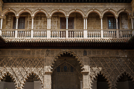 Detailed Mudejar plasterwork and arched galleries inside the Real Alcazar of Seville