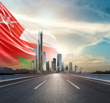 Oman national flag waving behind the cityscape. Oman national flag for independence day.