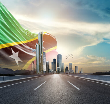 Saint Kitts and Nevis national flag waving behind the cityscape. Saint Kitts and Nevis national flag for independence day.