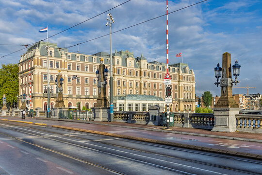Amsterdam, Netherlands - 28 August 2026. Luxury InterContinental Amstel Hotel building viewed from the bridge across the Amstel river with tram tracks in the foreground.
