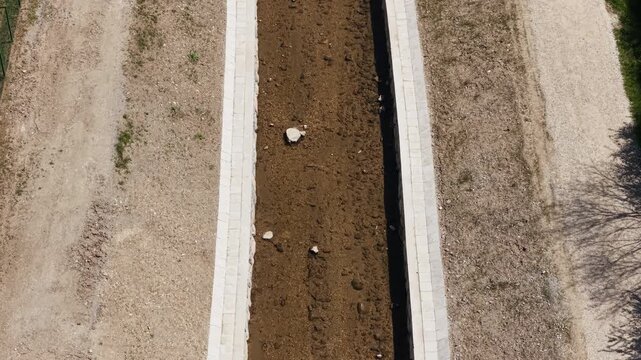 Drone view of a river restoration area showing cleaning and widening work for flood prevention and protection.