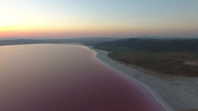 Pink Tuz Golu in Turkey shows mineral rich saline water and salt flats before sunset.