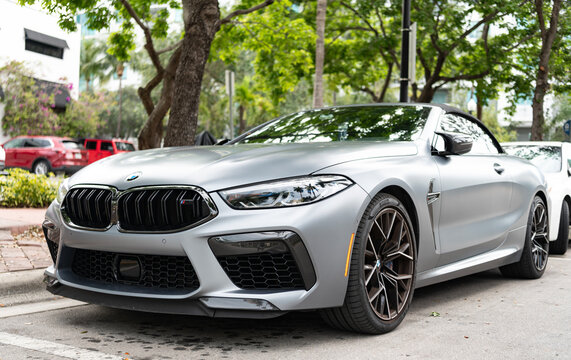 Miami, Florida, USA - May 05, 2025: BMW M8 Competition 2023 convertible car. Luxury convertible car BMW M8. Car BMW M8 convertible parked outdoor. Silver convertible car, low view