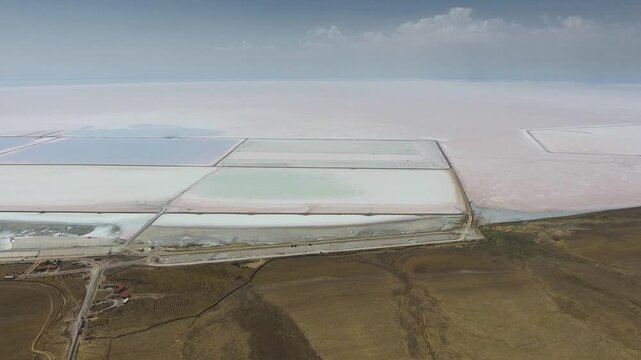 Aerial saltworks reveal evaporation ponds, levees, roads, and industrial basins beside Tuz Golu.