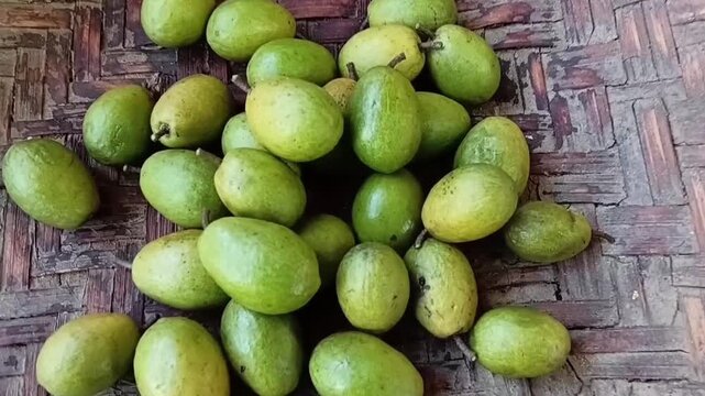 Horizontal Close Up Zoom In Shot of Ripe Ceylon Olives Elaeocarpus Serratus in Woven Bamboo Winnowing Basket