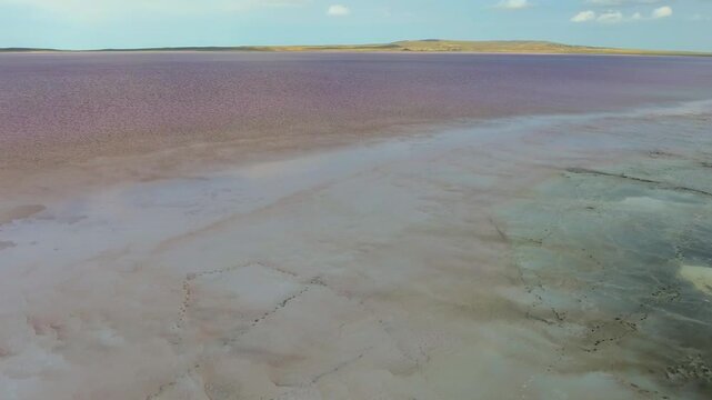 Pink Tuz Golu in Turkey shows mineral rich saline water and salt flats before sunset.