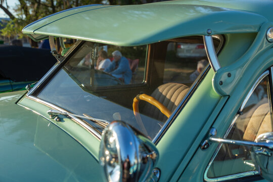 Green antique classic auto at a car show