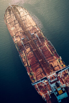 Oil tanker ship viewed from above on water in a beach