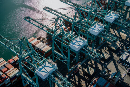 Container cranes loading cargo ship in a beach