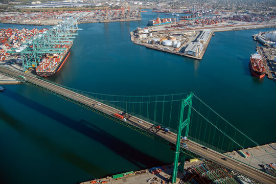 Suspension bridge over shipping port with container ships