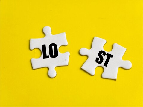 Two disconnected white puzzle pieces bearing the letters Lost.