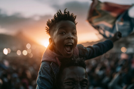 Excited Boy Waving South African Flag on Father Shoulders