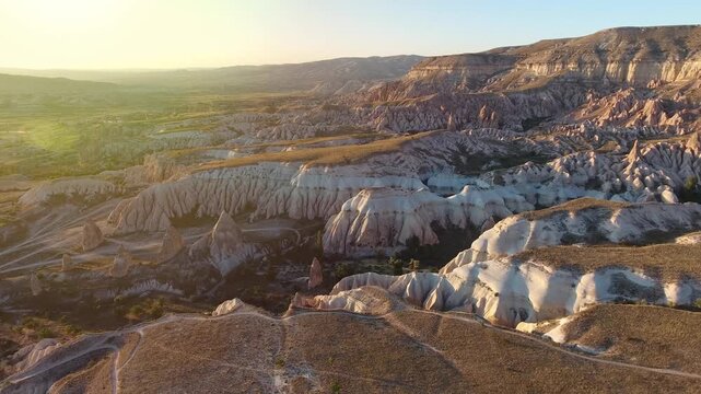 Aerial views sweep across Cappadocia fairy chimneys, valleys, and eroded tuff landscapes.
