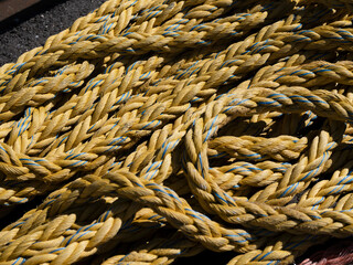 The twisted strands of a heavy yellow mooring rope fill the frame, a study of texture and maritime material. © Victor