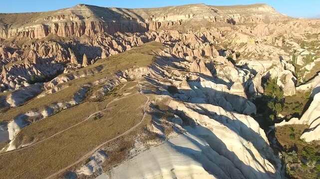 Aerial views sweep across Cappadocia fairy chimneys, valleys, and eroded tuff landscapes.