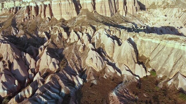 Aerial views sweep across Cappadocia fairy chimneys, valleys, and eroded tuff landscapes.